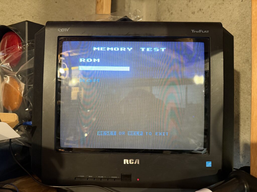 a television displaying the text "memory test, ROM, RAM" there is a white box under the word ROM