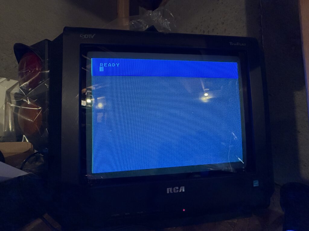 a television showing a blue screen with the word "Ready"