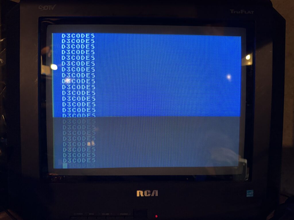 a television showing a blue screen with the word "D3CODES" printed several times